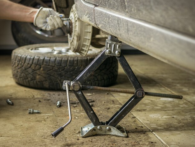 Disassembled car on a Jack in the garage.