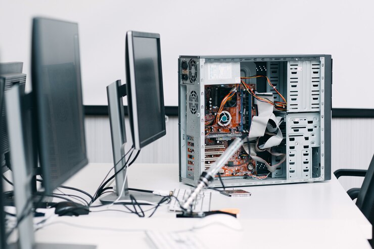 Photo disassembled computer unit on table with monitors. electronic repair shop, workshop, industry, renovation concept