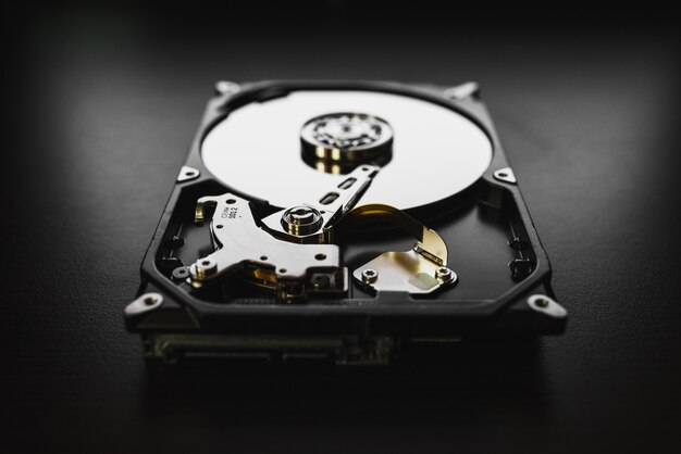 Photo disassembled hard drive from the computer, hdd with mirror effects. part of computer pc, laptop