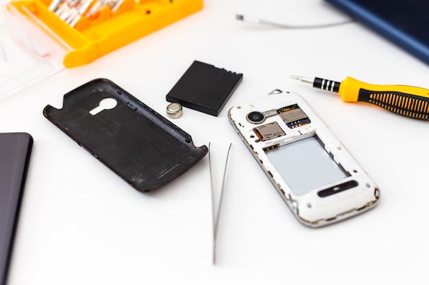 Disassembled smartphone, mobile phone repairing, flat lay, top view