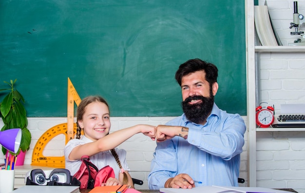 Discipline upbringing Man bearded pedagogue study together with kid Study is fun School teacher and schoolgirl Lesson is finished Task successfully done Homeschooling with father Help study