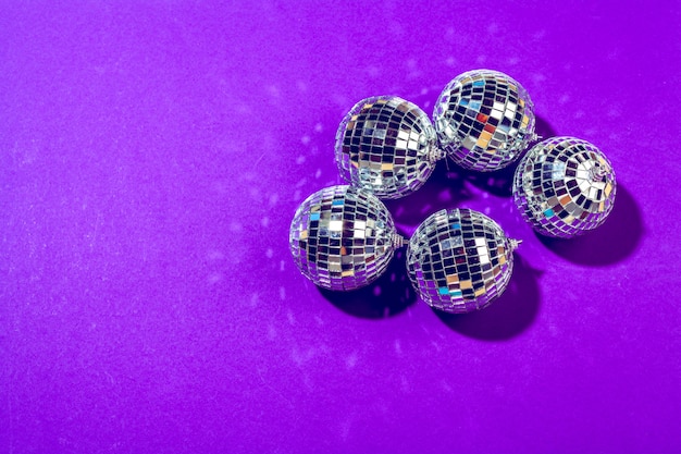 Disco ball shines on purple background close up