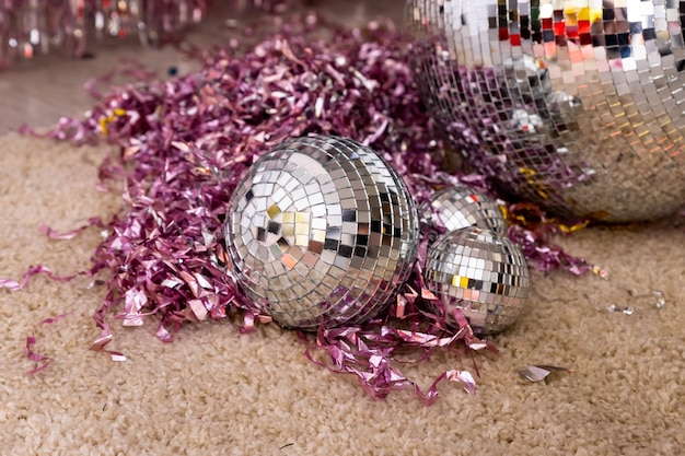 Disco ball with bright rays night party background.party\
atmosphere with disco globe decoration