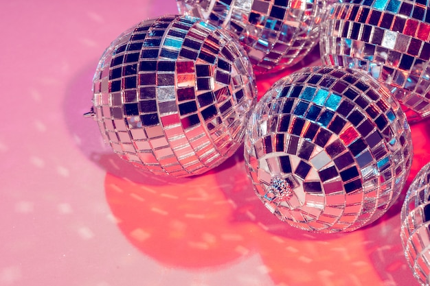 Disco balls for decorationof a party on pink