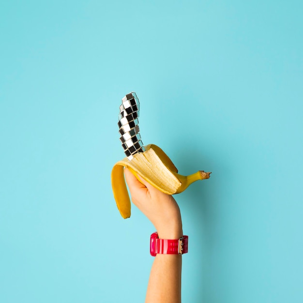 Disco banana design in hand on blue background