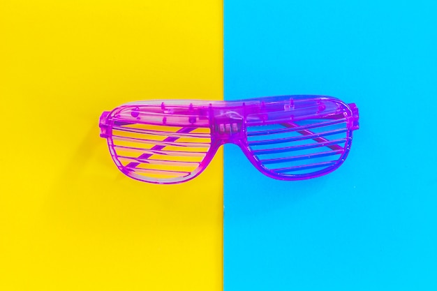 Disco party glasses on colourful background