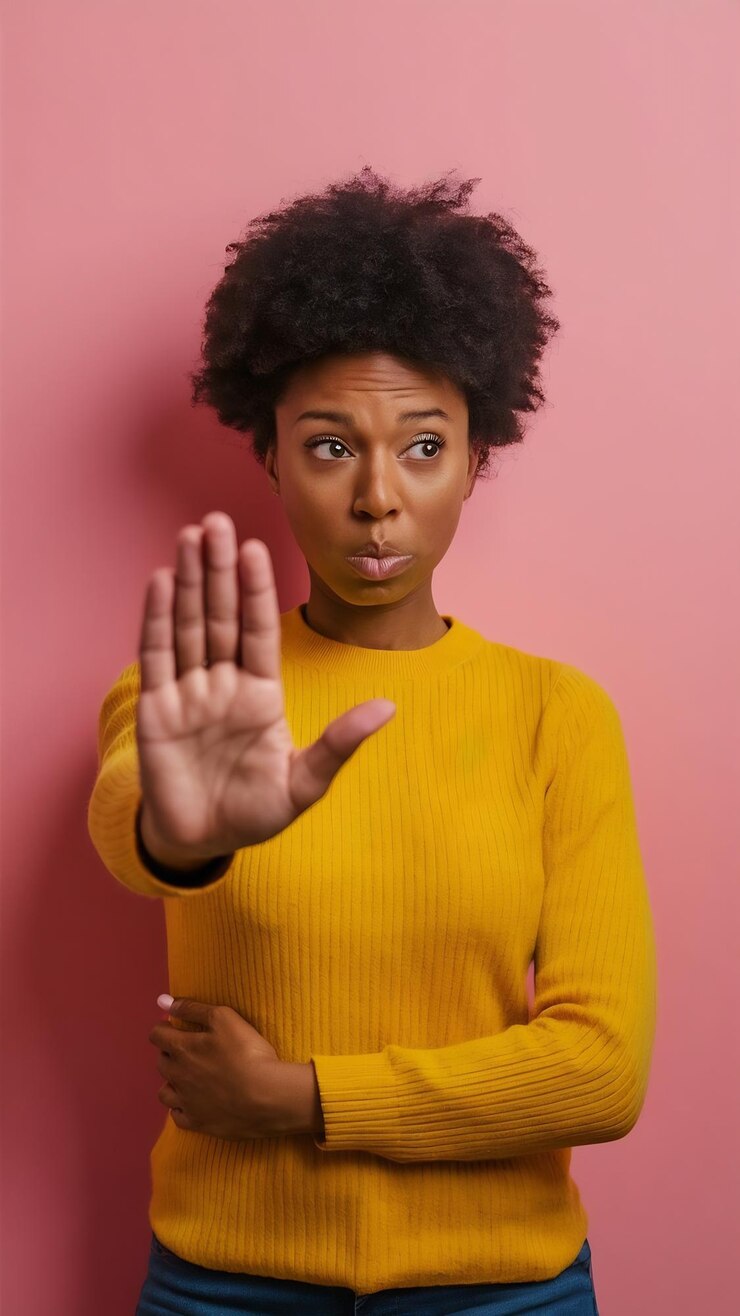 Photo discontent african american woman keeps palm in refusal gesture says stays away from me and do not