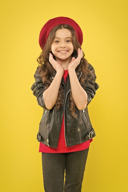 Discover the beauty within Happy beauty girl smiling on yellow background Beauty look of adorable small girl Little child with charming smile on beauty face and brunette long hair