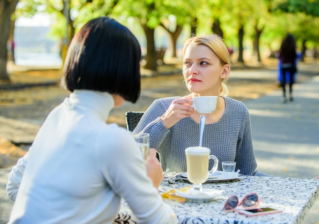 Discussing rumors trustful communication friendship sisters\
friendship meeting female leisure girls friends drink coffee talk\
conversation women cafe terrace friendship friendly relations