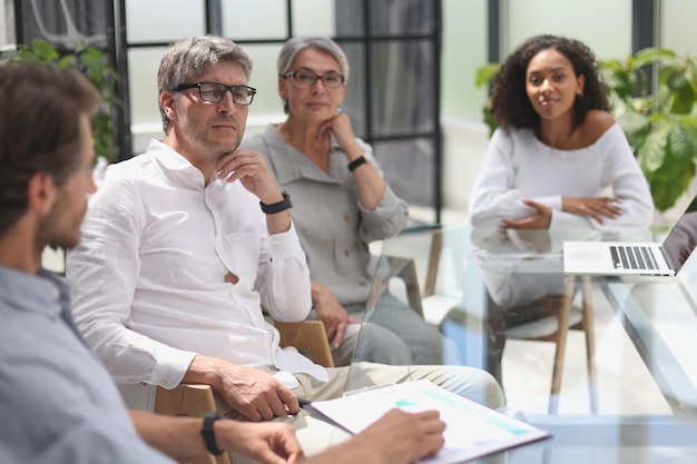 Discussion of business people in the office sitting at the table