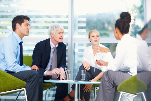 Discussione tra uomini d'affari ritratto di gruppo multietnico di affari che discutono insieme in ufficio