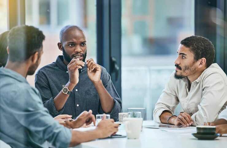 Photo discussion meeting and business people planning brainstorming and staff collaboration ideas and group listening speaking strategy and black man or employees in teamwork workflow and talking