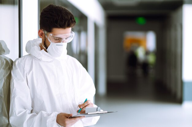 Disease control expert with a equipment to check the temperature at office.