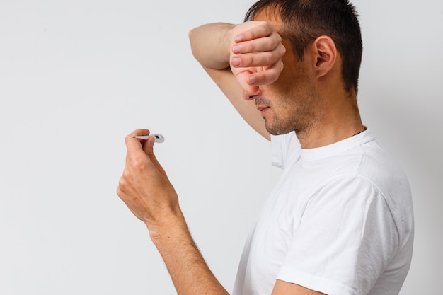 Diseased Teenager with thermometer in his mouth Isolated on the White Background