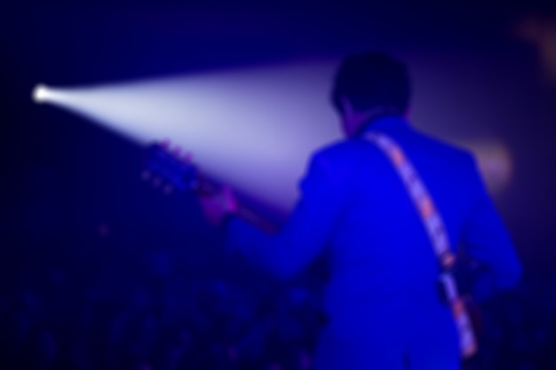 Disfocus of the guitarist on stage for background, colorful, soft focus and blur