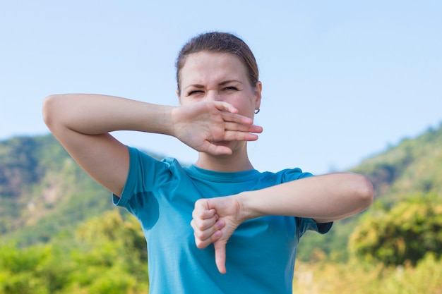 Disgusted upset girl in sweaty T-shirt