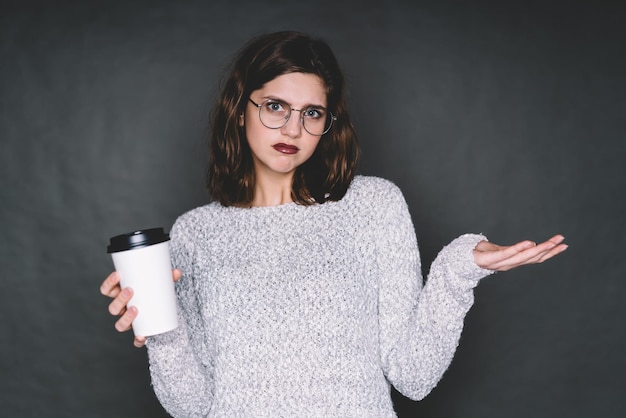 Disgusted woman with hot beverage