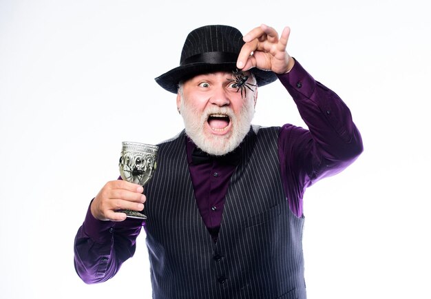 Disgusting Halloween drink Elegant bartender wear hat and vest prepare drink Horror themed Halloween party Weird old grandfather with gray beard Halloween concept Add spider cocktail recipe