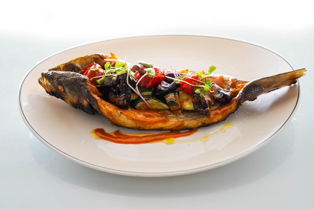 Dish of baked bream with vegetables in a gourmet restaurant.