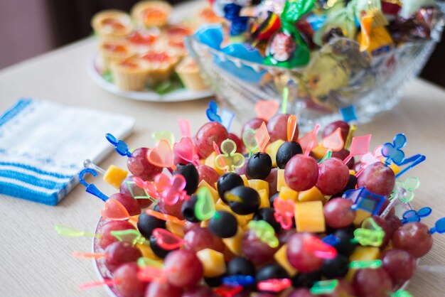 a dish of canapes of fruits and berries on a festive plate