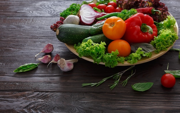 Dish of fresh vegetables on wood with copy space