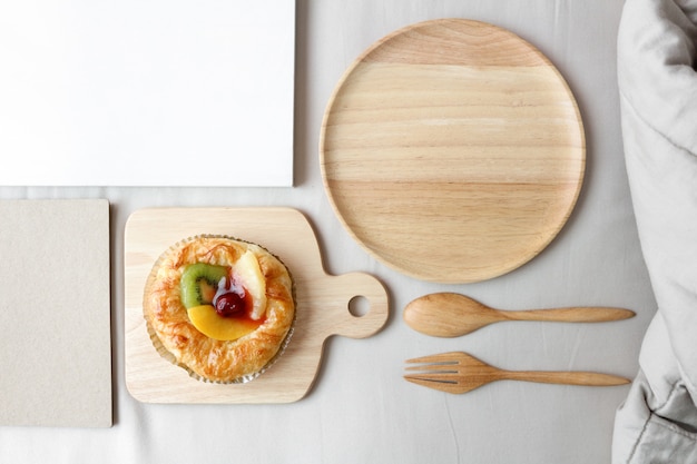 Photo dish of mixed fruits pies is on top of the bed.