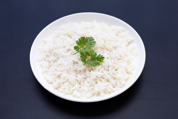 Dish of rice on dark background.