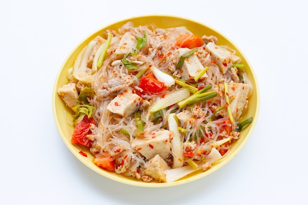 Dish of spicy vermicelli salad on white background.