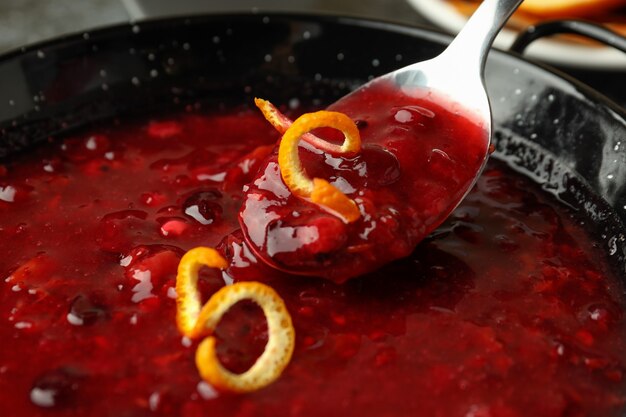 Dish and spoon with cranberry sauce, close up