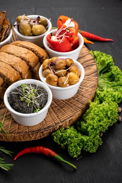 Dish with assorted marinated vegetables on wooden background