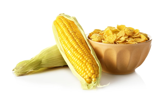 Dish with cornflakes and cobs on white background