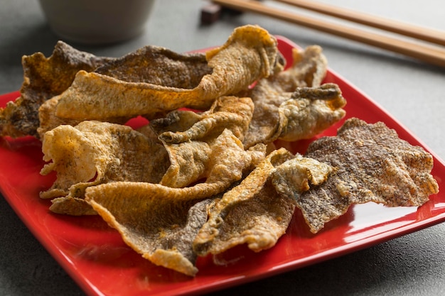 Dish with crispy baked and seasoned salmon skin close up