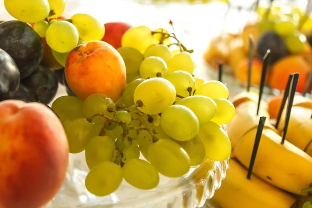 Dish with fruit on the festive table