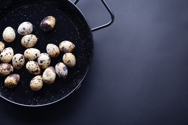 Dish with quail eggs on dark