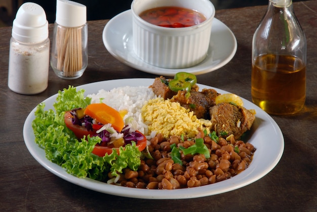 Dish with rice, beans, meat and salad