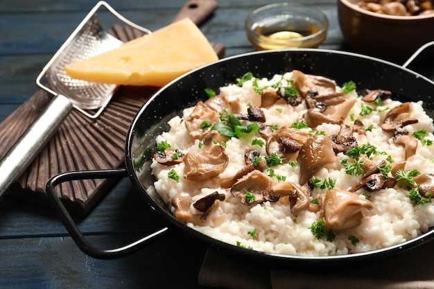 Dish with risotto and mushrooms on table