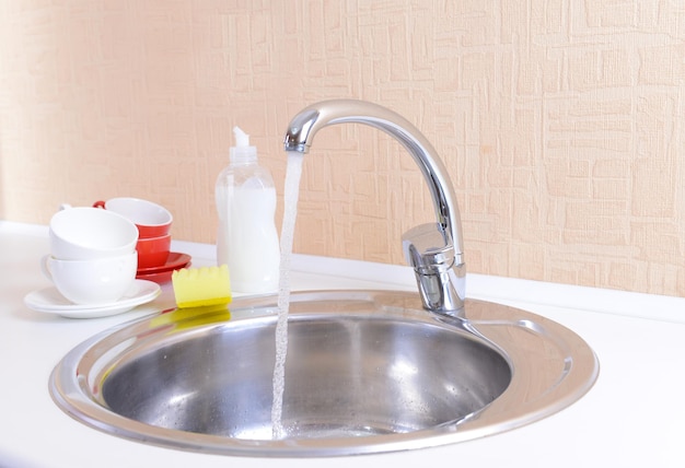 Dishes drying near metal sink