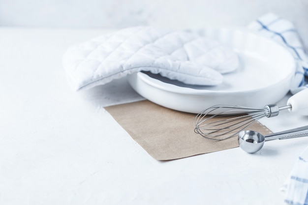 Dishes and kitchen accessories for baking on the Kitchen table on a white background