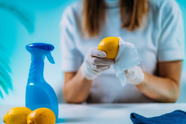 Disinfecting Fruit Woman Disinfecting Lemon with Wipes and Alcohol based disinfectant