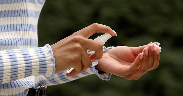 Disinfecting hands on street. Woman sanitaze her hands.