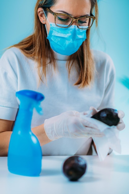 Disinfection of Food Woman Disinfecting Surface of Avocado with Wipes and Alcohol based disinfectant