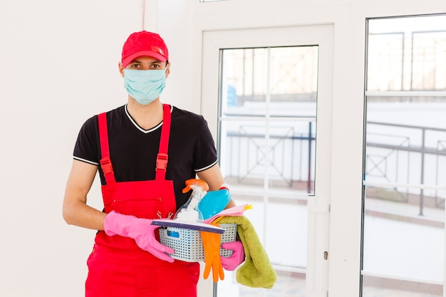 Disinfection for virus killing. worker in protection mask\
cleaning interior using chemical agents to stop spreading virus\
infections.