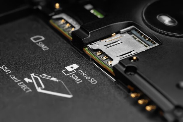 dismantled smartphone closeup of a disassembled gadget with sim card connectors