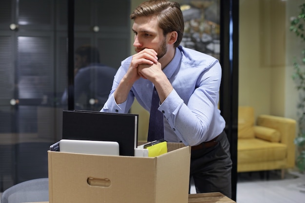 Dismissed worker going from the office with his office supplies.