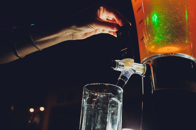 Dispenser and glasses with cold beer on table