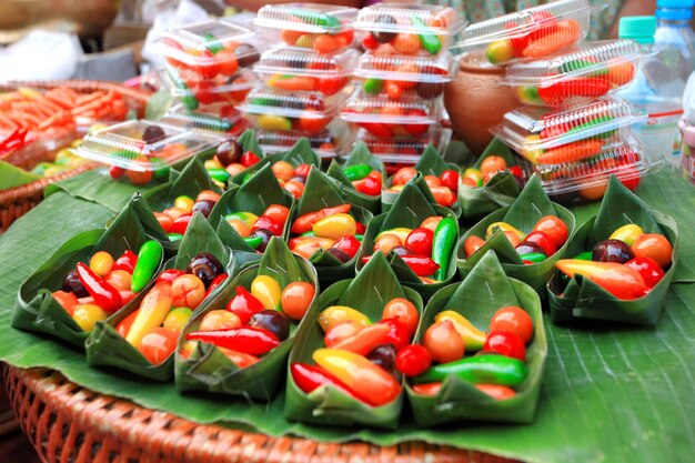 A display of candy in plastic containers with the word candy on them.