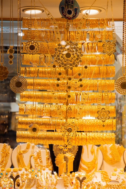 Photo display of dozens of golden bracelets in turkish style