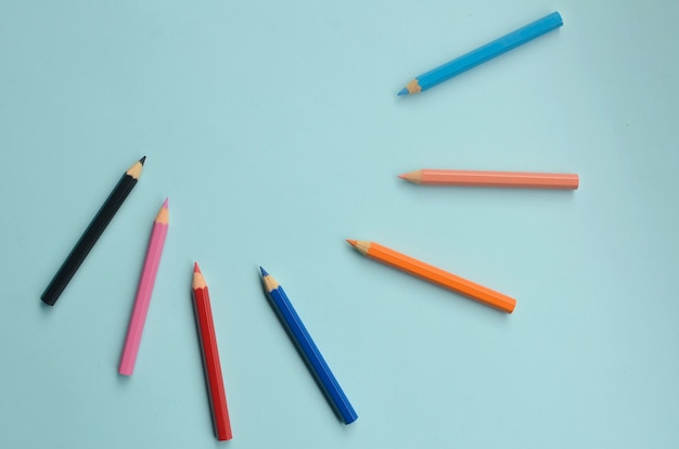 display of the empty space with colored pencils the concept of colored pencils on a blue background