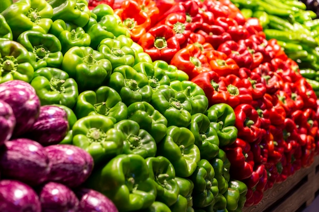 Display of stacked red and green peppers