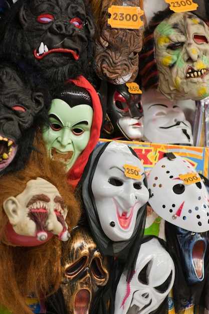 Display wall of halloween scary faces masks on sale in joke shop